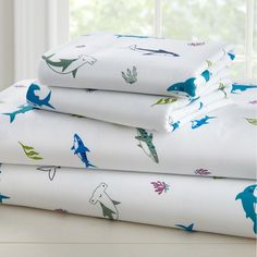 three sheets with blue and green dinosaurs on them