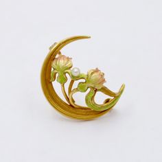 "A darling 14K gold Art Nouveau era crescent and lotus flower pin by Newark, NJ jewelry house Krementz. Known for their delicate enamel work, this antique pin is the perfect example of their fine craftsmanship. The gradient enameling from green to pink shown in the flower is really quite lovely. The back of the pin is stamped \"14K\" with the maker's mark as well. Metal: 14K Yellow Gold Weight: 2.5 grams Pearl: 2.3 mm Measurements: 0.8 inches long by 0.9 inches wide Markings: \"14K\" and maker's Lalique Jewelry, Bijoux Art Nouveau, Antique Pins, Art Nouveau Jewelry, Pin Pendant, Enamel Flower, Gold Art, Flower Pins, Vintage Jewels