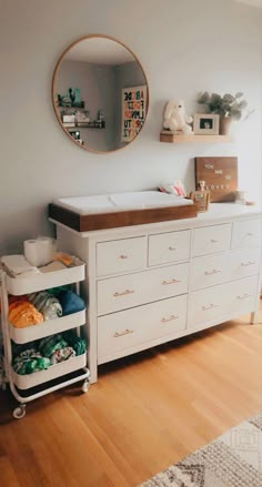 a baby crib is shown in the corner of a room with a mirror on the wall