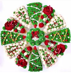 decorated cookies are arranged in the shape of a christmas tree with red and green frosting