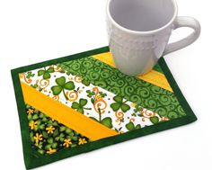 a coffee cup sitting on top of a green place mat