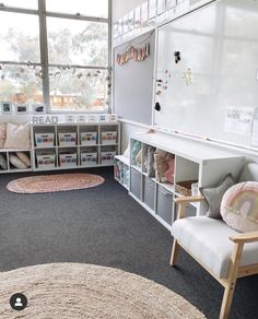 a child's playroom with toys, bookshelves and storage bins