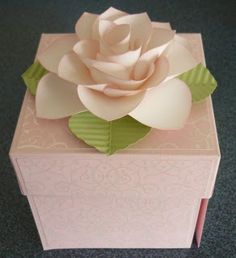 a pink and green box with a flower on top