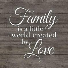 a wooden wall with the words family is a little world created by love on it