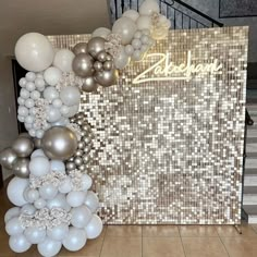 balloons and streamers are arranged on the floor in front of a sign that reads zabeean