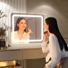 a woman standing in front of a mirror looking at the reflection of herself on her face