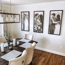 a dining room table with chairs and pictures on the wall