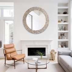 a living room with a couch, chair and fireplace