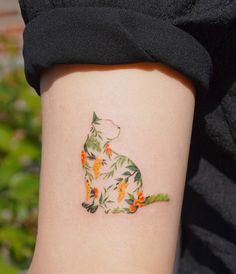 a cat tattoo on the left side of the leg, with orange flowers all over it