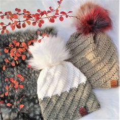 two knitted hats with red and white pom - poms