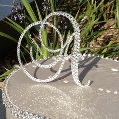 a cake that is sitting on top of a silver plate with some crystal beads around it