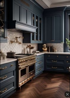 a kitchen with blue cabinets and gold trim on the stove top, along with wooden flooring