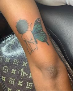 a woman with a butterfly tattoo on her arm