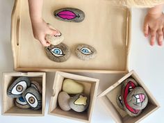 the child is playing with rocks in their play area, including one for each rock