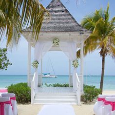 the gazebo is decorated with pink and white linens