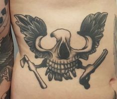 a skull and two crossed swords on the side of a woman's stomach,