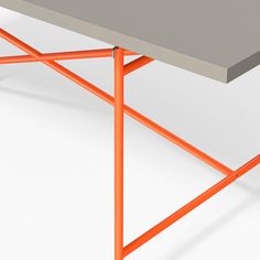 an orange and gray table sitting on top of a white floor