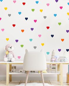 a child's room with hearts on the wall and a teddy bear sitting in front of it