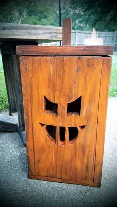 an old wooden box with holes in the front and sides that have been carved into it