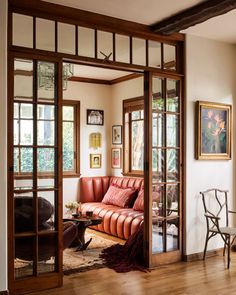 a living room filled with furniture and lots of windows