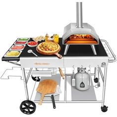 an outdoor pizza oven on wheels with various foods cooking in the grill and serving utensils