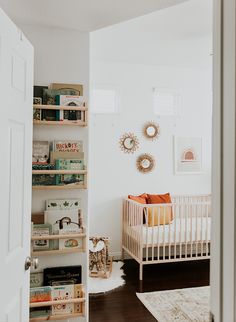 a baby's room with bookshelves and a crib