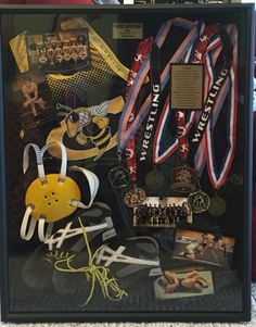 a display case filled with medals and other sports related items on top of a carpeted floor