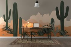 a desk with a laptop on it in front of a cactus wall mural