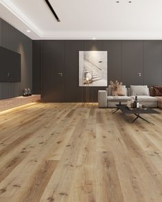 a living room with wood flooring and grey walls, along with a couch in the center