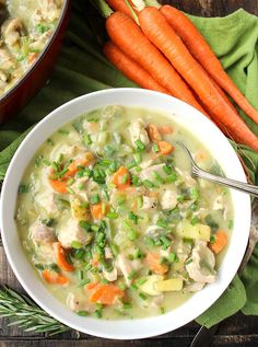 a bowl of chicken and vegetable soup with carrots