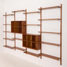 an empty room with shelving units on the wall