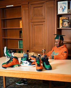 a man sitting at a table with some shoes on it