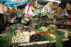 an outdoor market with lots of fresh produce