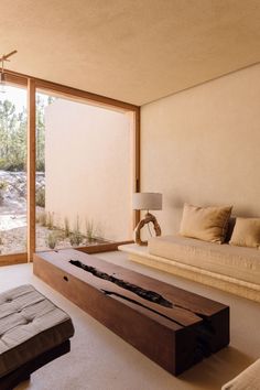 a living room filled with furniture and large windows