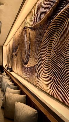 the wall is made out of wood and has wavy lines on it, along with white bean bags