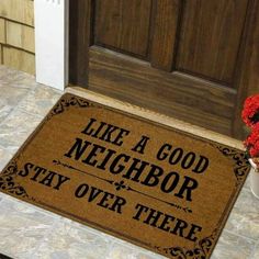 a door mat that says like a good neighbor stay over there on the front porch