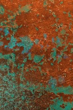 an old rusted metal surface with blue and green paint