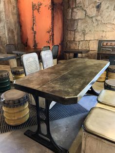 an old fashioned table and chairs in a room with stone walls, flooring and wood floors