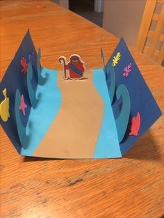 a paper crown sitting on top of a wooden table