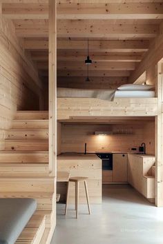 the interior of a cabin with wooden walls and stairs