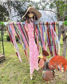 a scarecrow wearing a straw hat and sunglasses