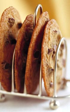 four cookies in a metal holder on a table