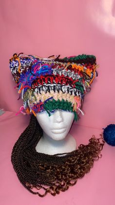 a white mannequin head with multicolored crochet hair