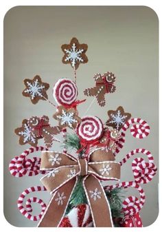 a christmas tree made out of candy canes and gingerbreads with snowflakes on top