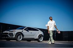 a man standing next to a white car