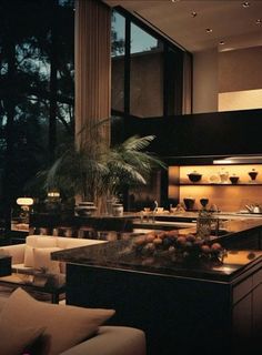 the kitchen is very large and well lit up at night, with no one in it