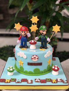 a birthday cake with mario and luigi on top