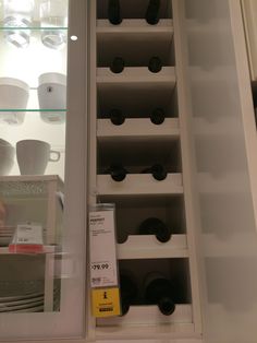 there are many cups and plates on the shelves in this kitchen display case that is also for sale