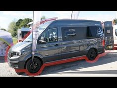 an image of a van that is parked in the street with other vehicles behind it