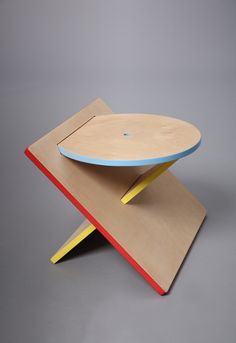 a wooden table with a blue and yellow top